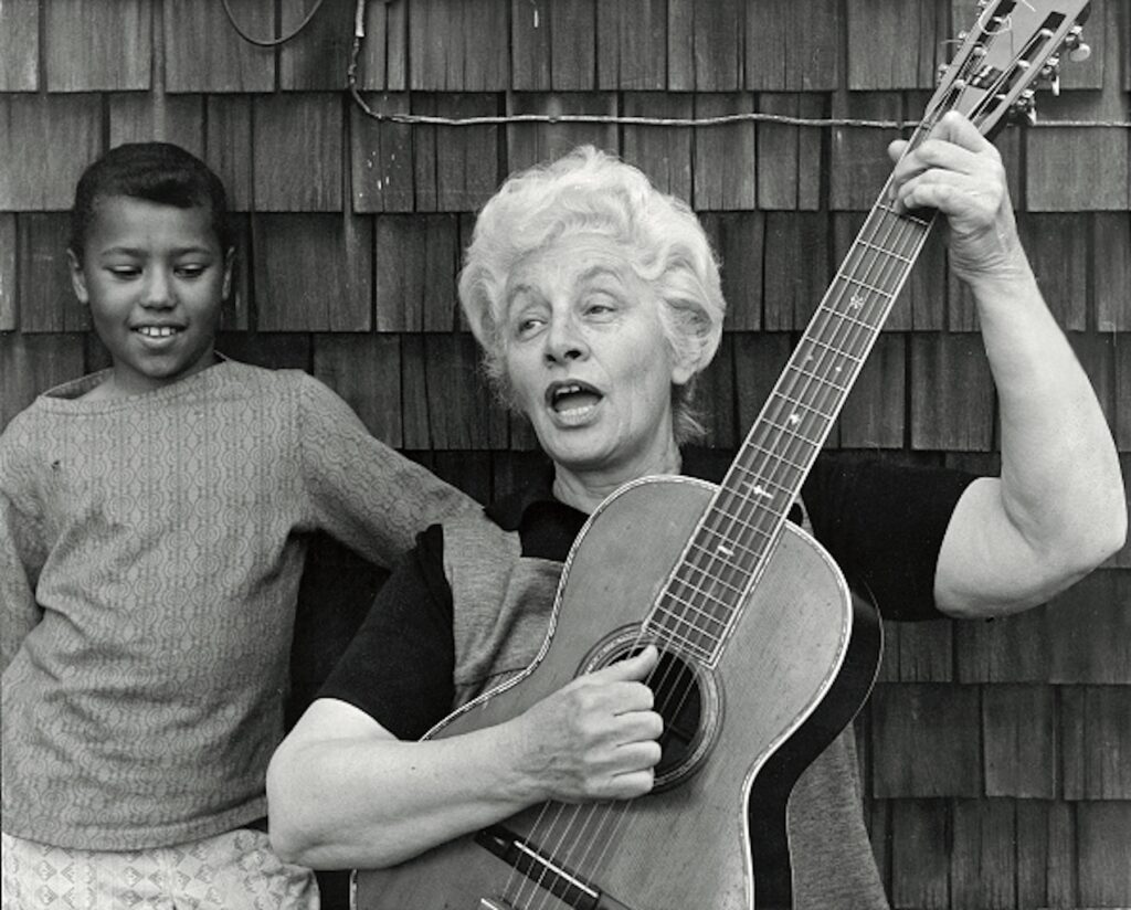 Malvina Reynolds with a guitar