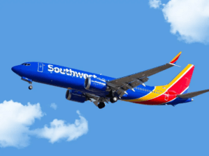 southwest plane flying against a bright blue sky.