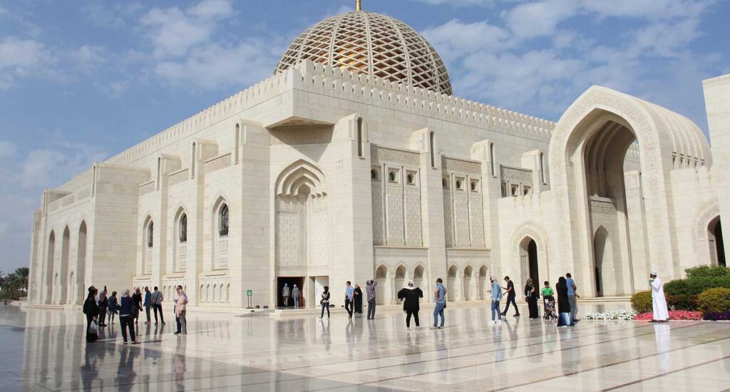 Sultan Qaboos Grand Mosque under a blue sky