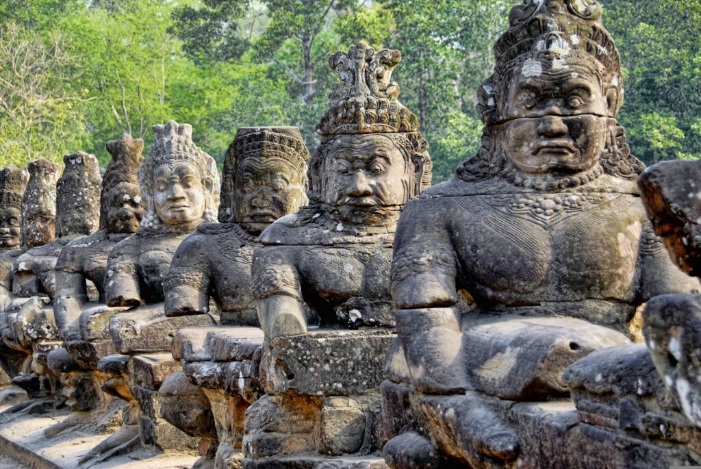 Diagonal row of large Cambodian statues