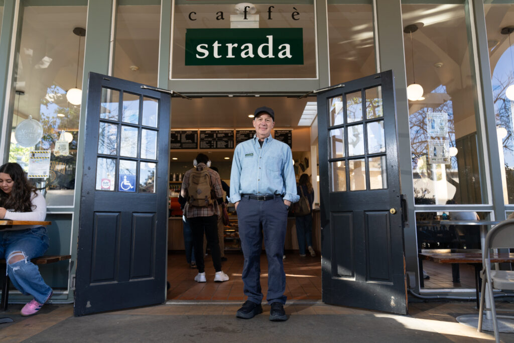 Daryl Ross stands under Caffè Strada's door way.