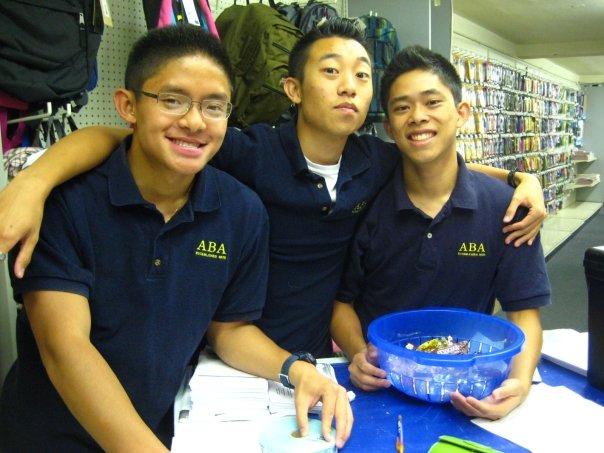 Young Kevin Lee posing with two friends.