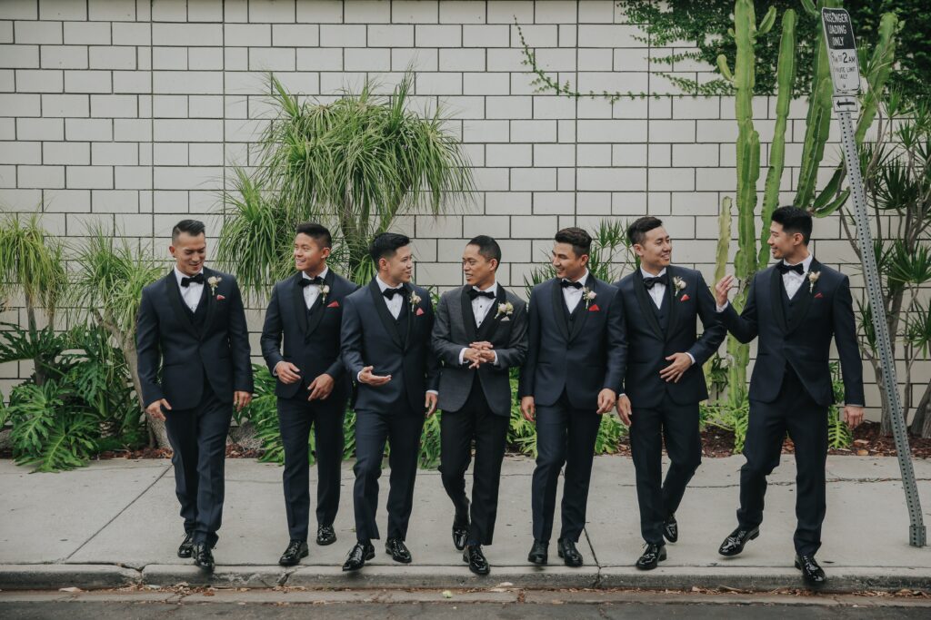 Kevin Lee posing with his groomsmen at his wedding.