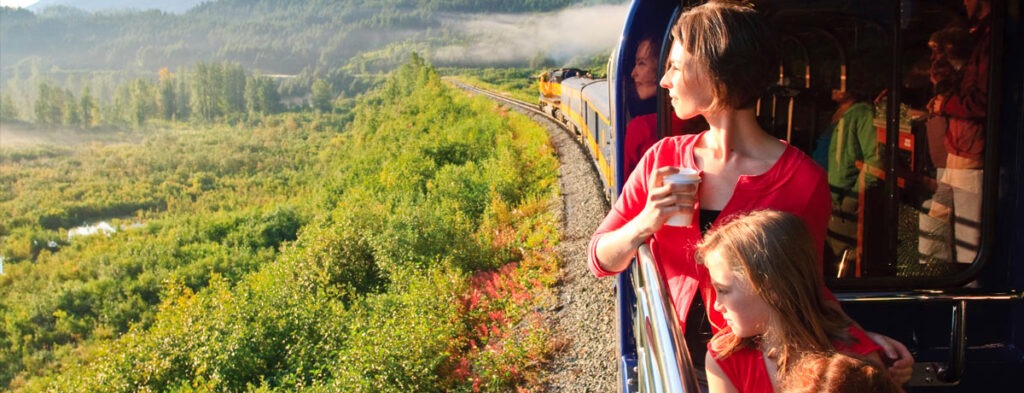 passengers look out windows of train