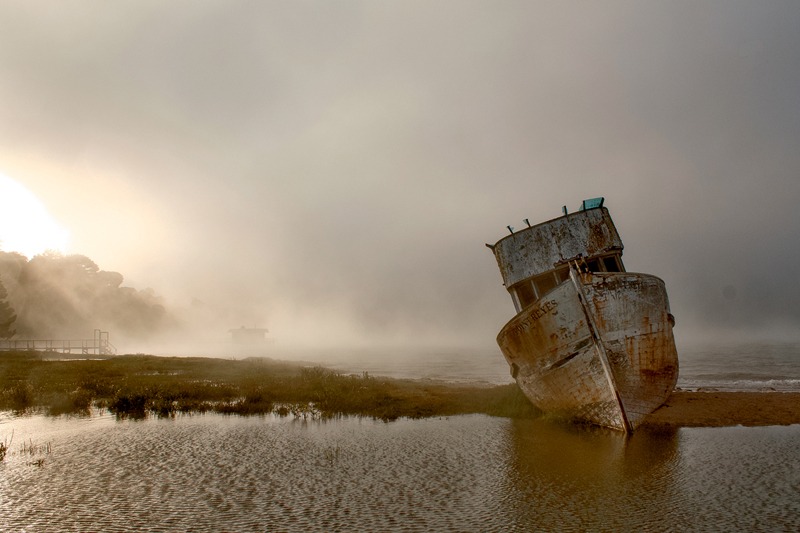The boat “Point Reyes” lies on the flats of Tomales Bay