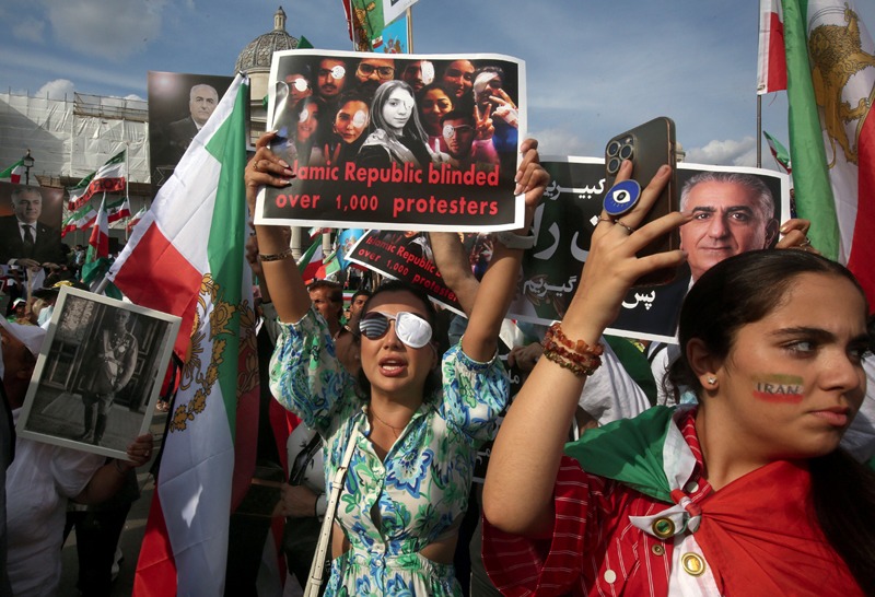 A protester wearing an eye patch holds a placard saying 'Islamic Republic blinded Over 1000 Protesters' in Trafalgar Square.  (Photo by Martin Pope / SOPA Images/Sipa USA)(Sipa via AP Images)