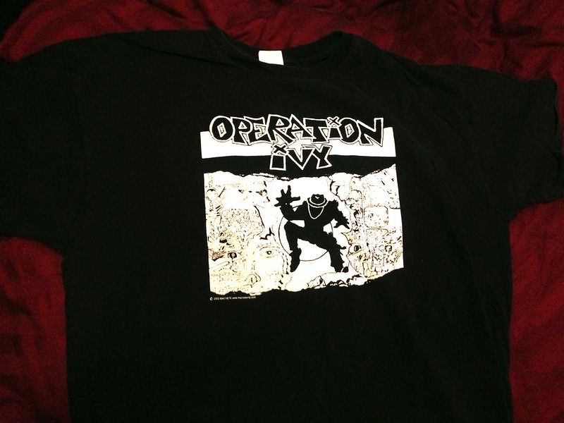 Photo of a black band t-shirt with the Operation Ivy logo stamped.