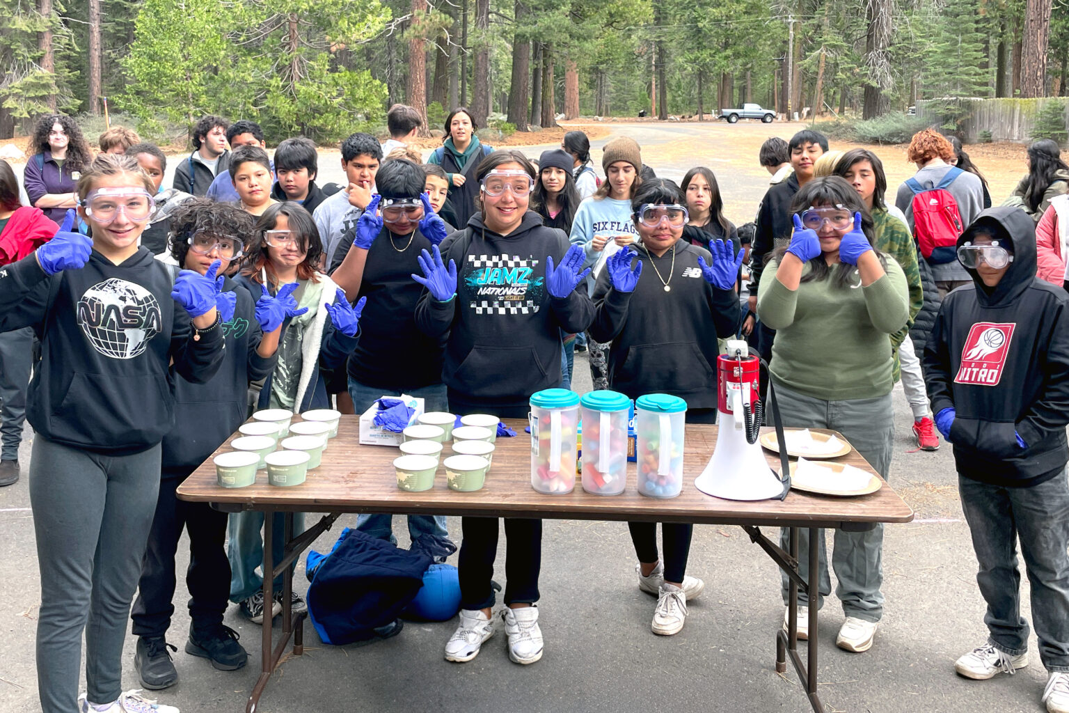 science campers wearing goggles and gloves prepare for an outdoor science activity