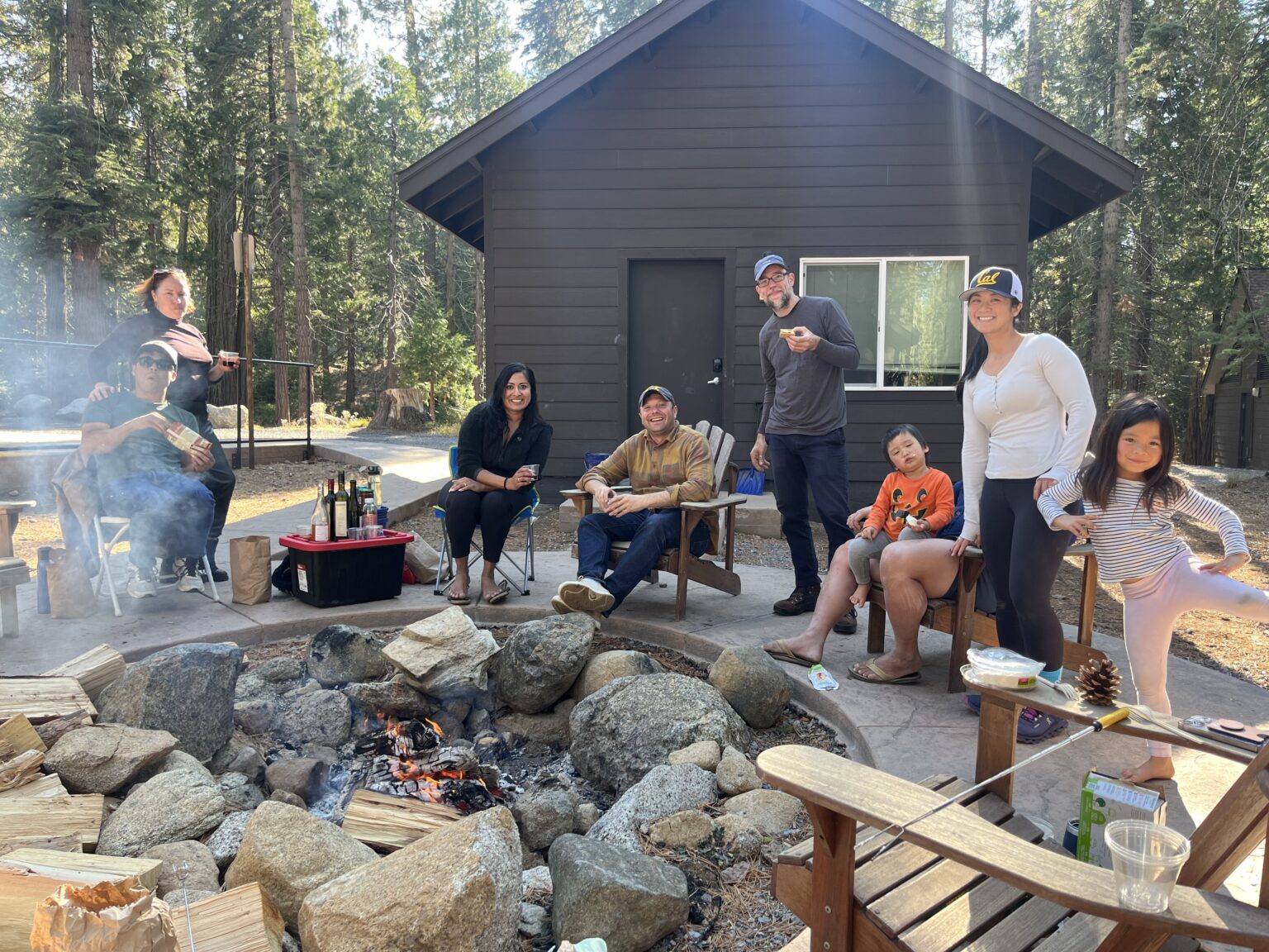 Oski guests enjoying an afternoon, sitting around a firepit.