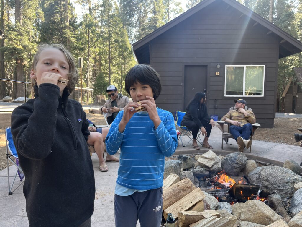 Two kids enjoying s'mores around an Oski firepit.