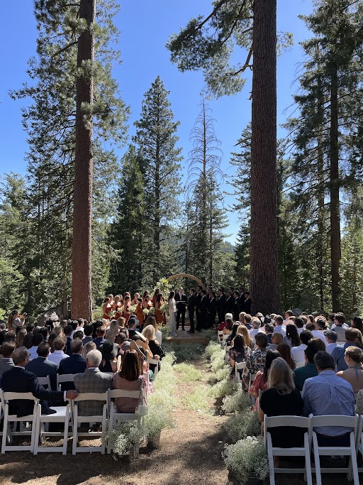 Many people seated for an outdoor wedding ceremony