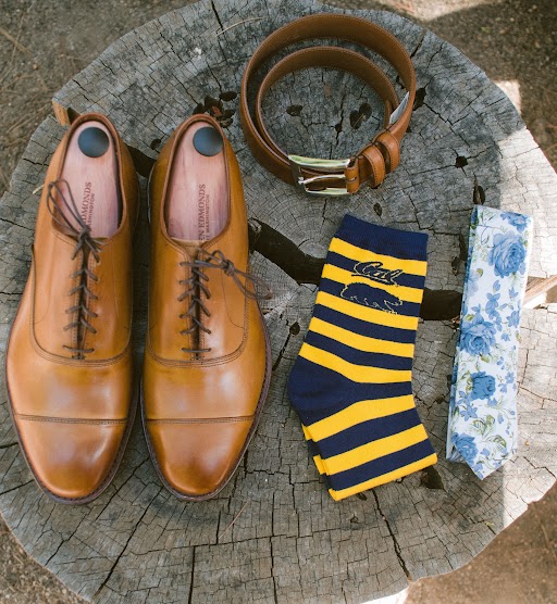 Groom's accessories set out on a tree stump