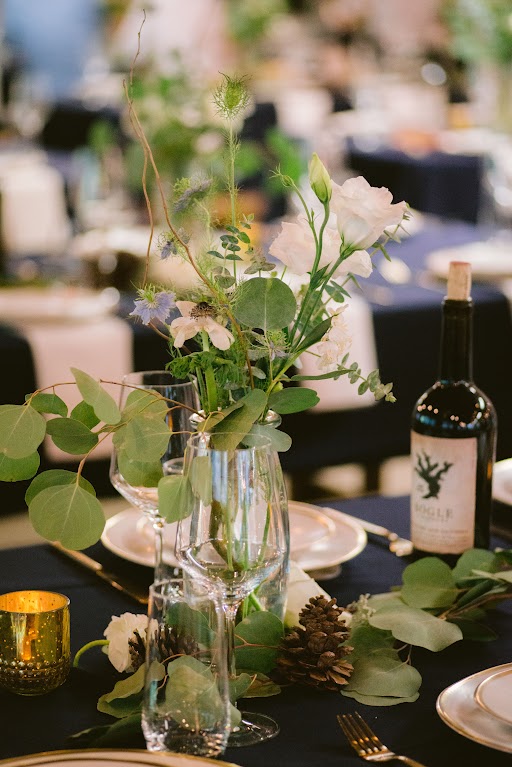 a close up of a centerpiece and place setting for a wedding at the Lair