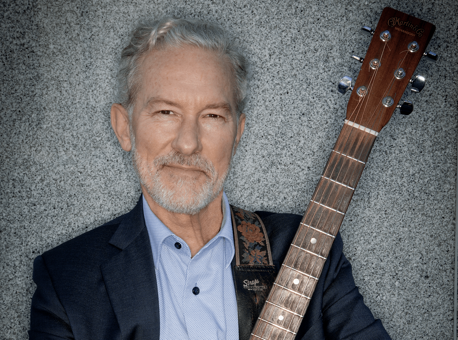 Photo of Rich Lyons holding a guitar