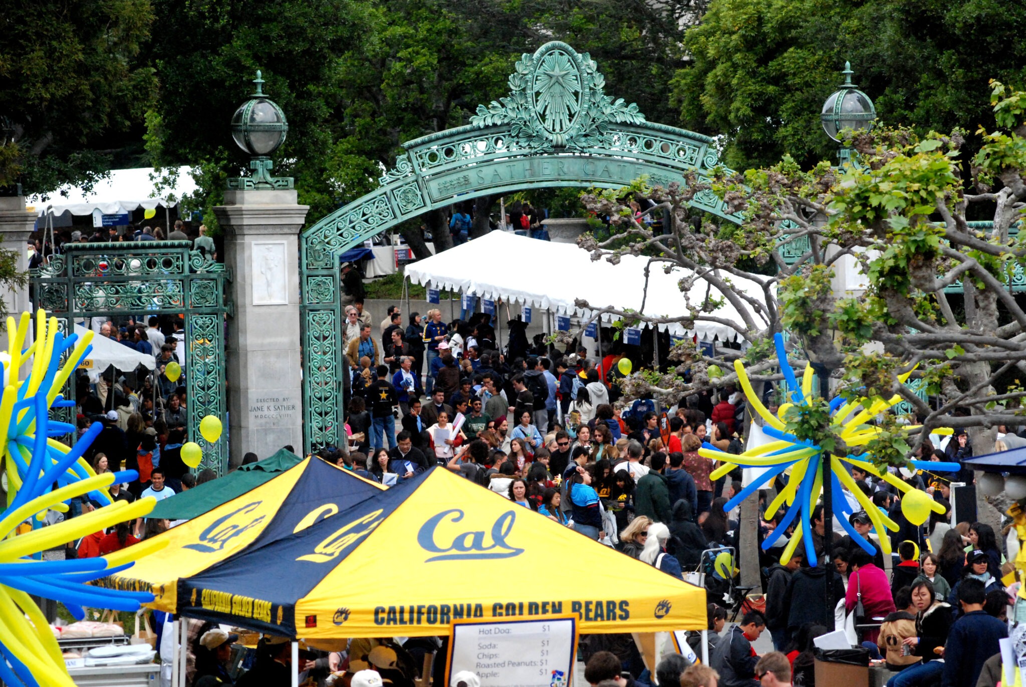 Students, faculty, and families walking around Sather Gate and Sproul Plaza.