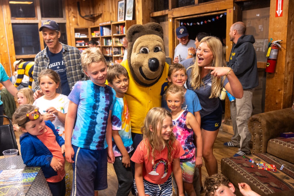 Oski posing with campers at the Lair