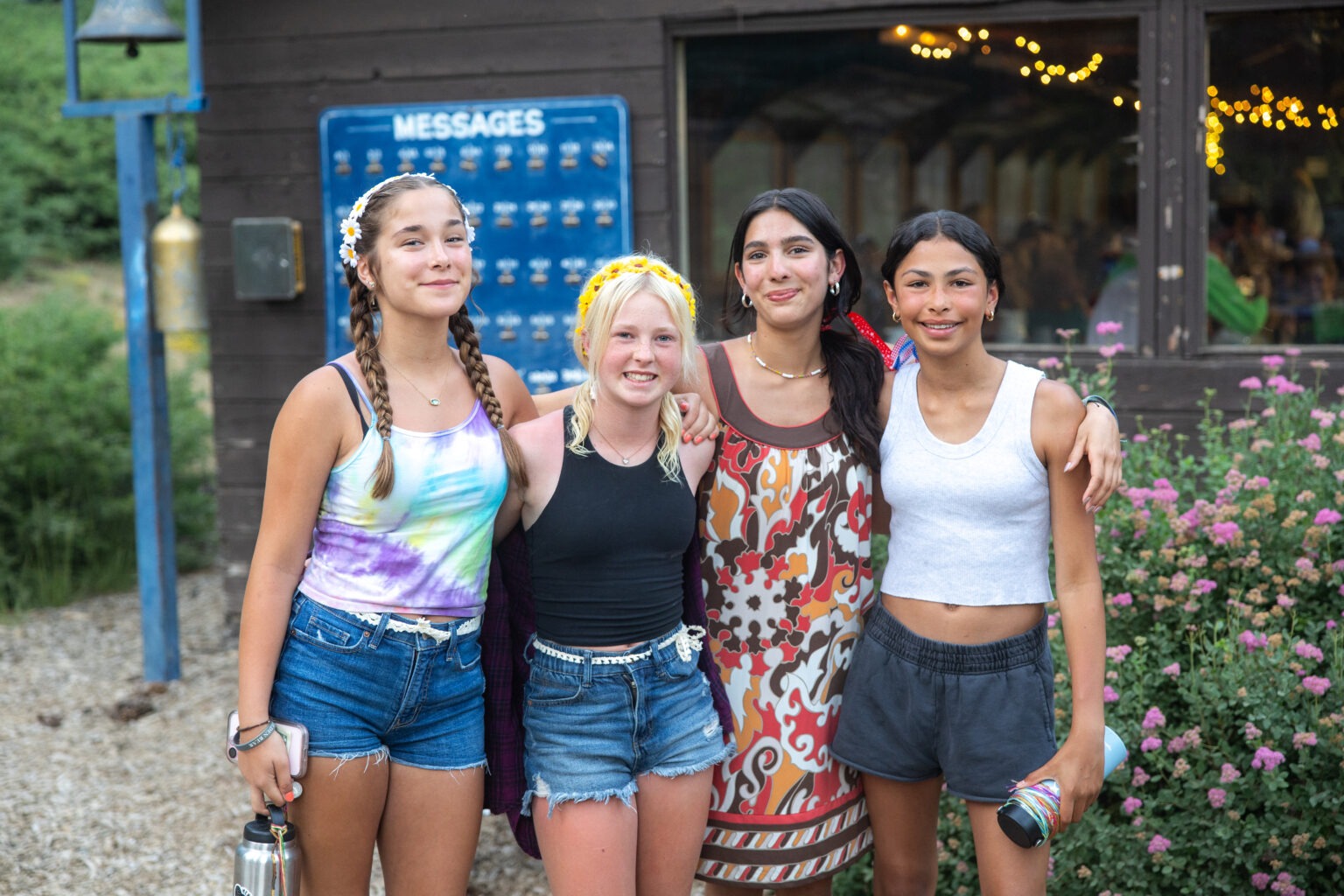 Four teens dressed and ready for Disco Bingo, standing outside the Blue Dining Hall.