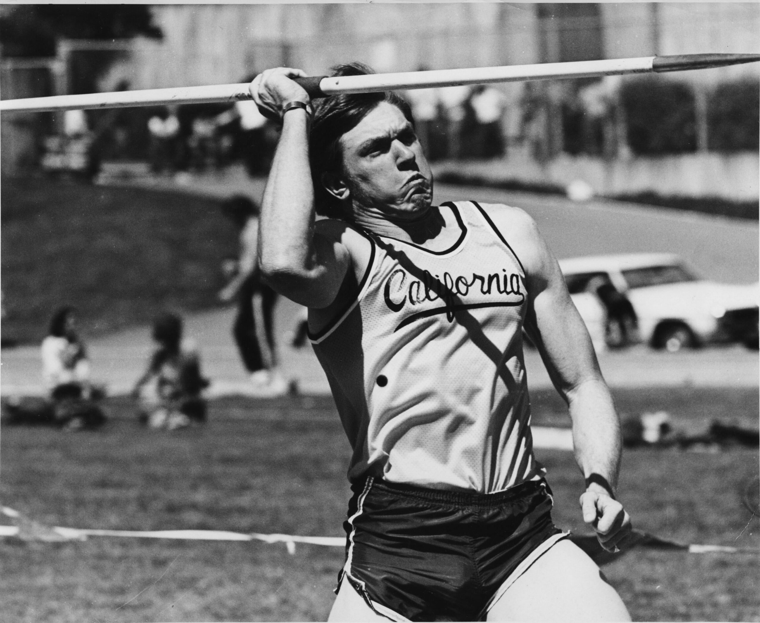 thrower Bruce Kennedy in action, wearing a "California" athletic uniform