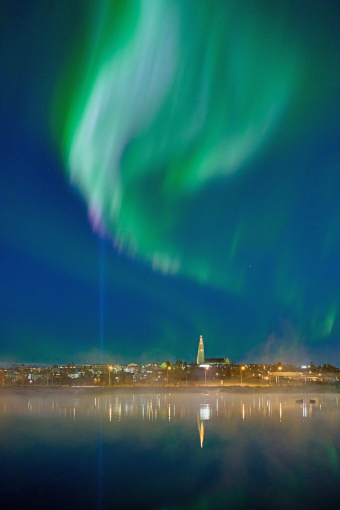 A green aurora borealis over Reykjavik city