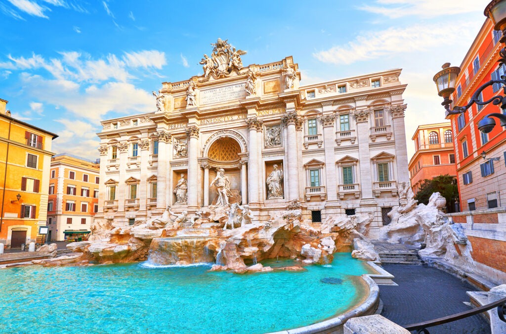 The Trevi Fountain in Rome, showcasing stunning baroque architecture, flowing water, and classical sculptures against a bright sky