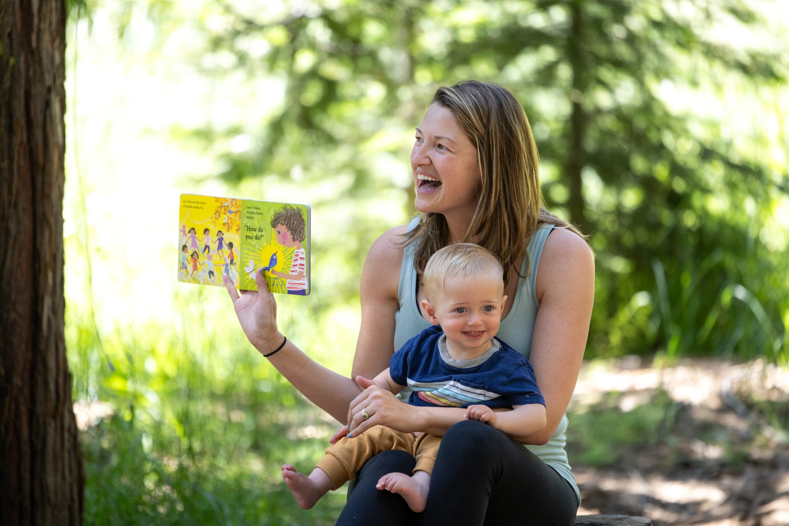 Campers turn the pages of a colorful picture book, sharing a story with the community.