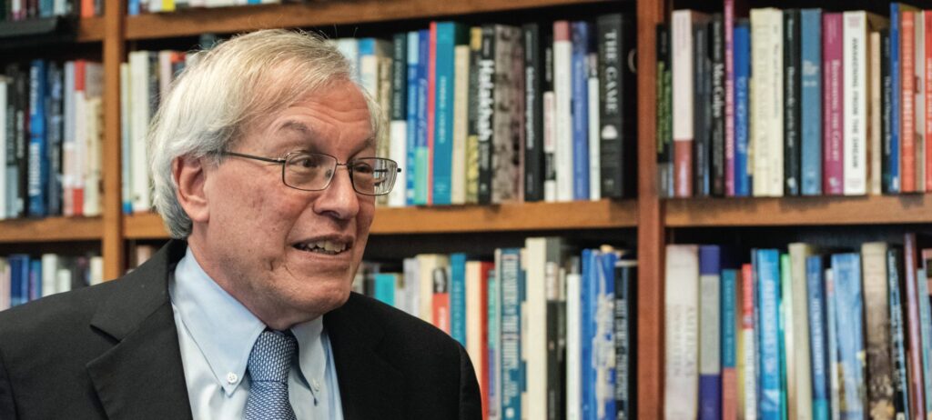 Chemerinsky speaking in front of a bookshelf